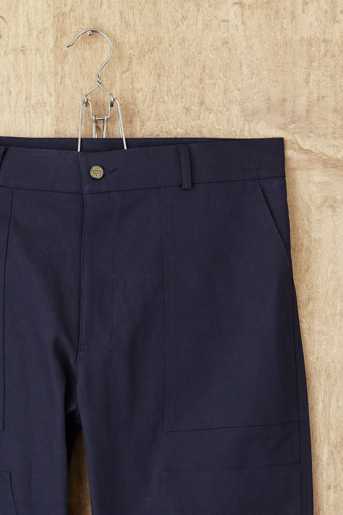 The navy Dufferin Double Knee Pant hanging front-on, the reinforced double knee panel visible across both legs