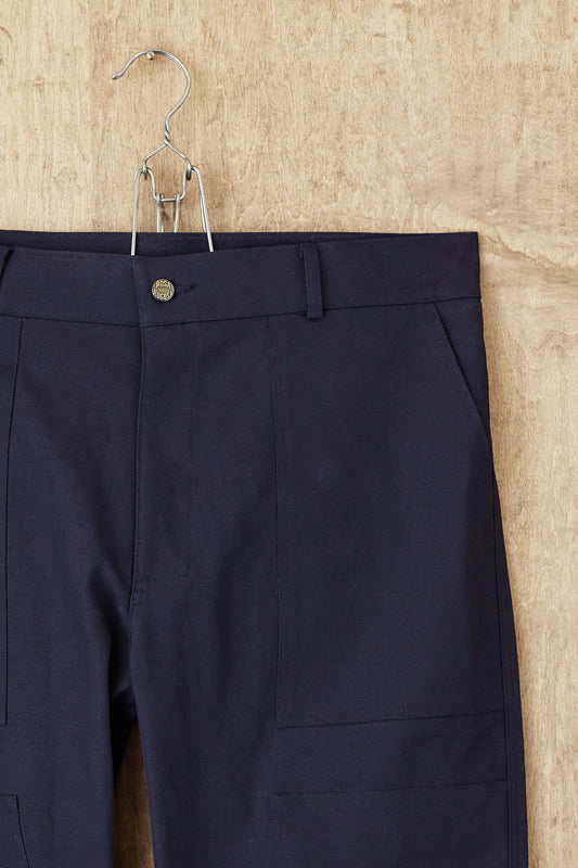The navy Dufferin Double Knee Pant hanging front-on, the reinforced double knee panel visible across both legs